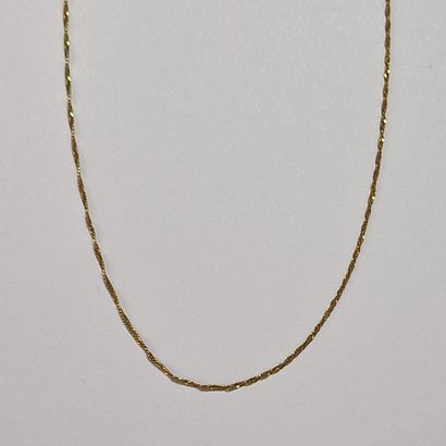 Modern twisted-link chain in yellow gold...