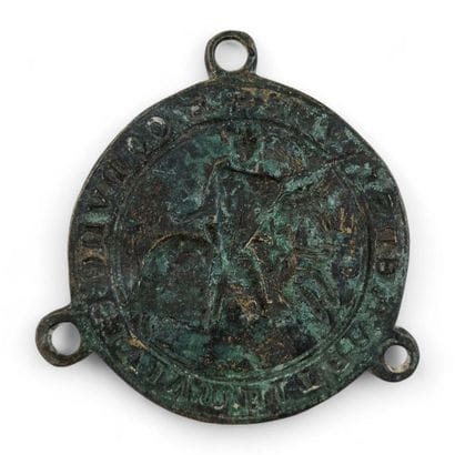 Circular seal in green patina bronze, with...