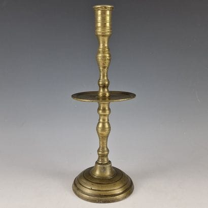 Bronze TORCH. Circular base; turned shaft...