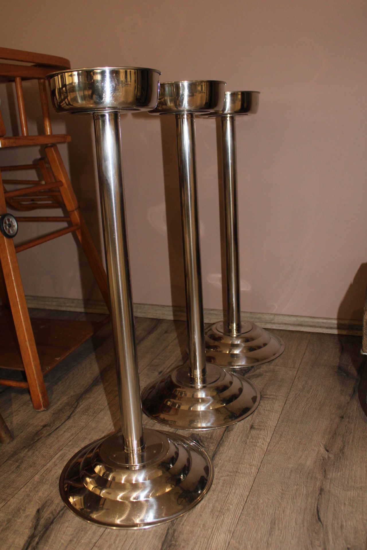 Null Three champagne bucket holders, chromed metal (66 cm high).