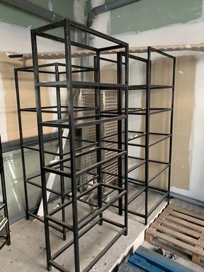 Null Five shelving units in steel or similar.